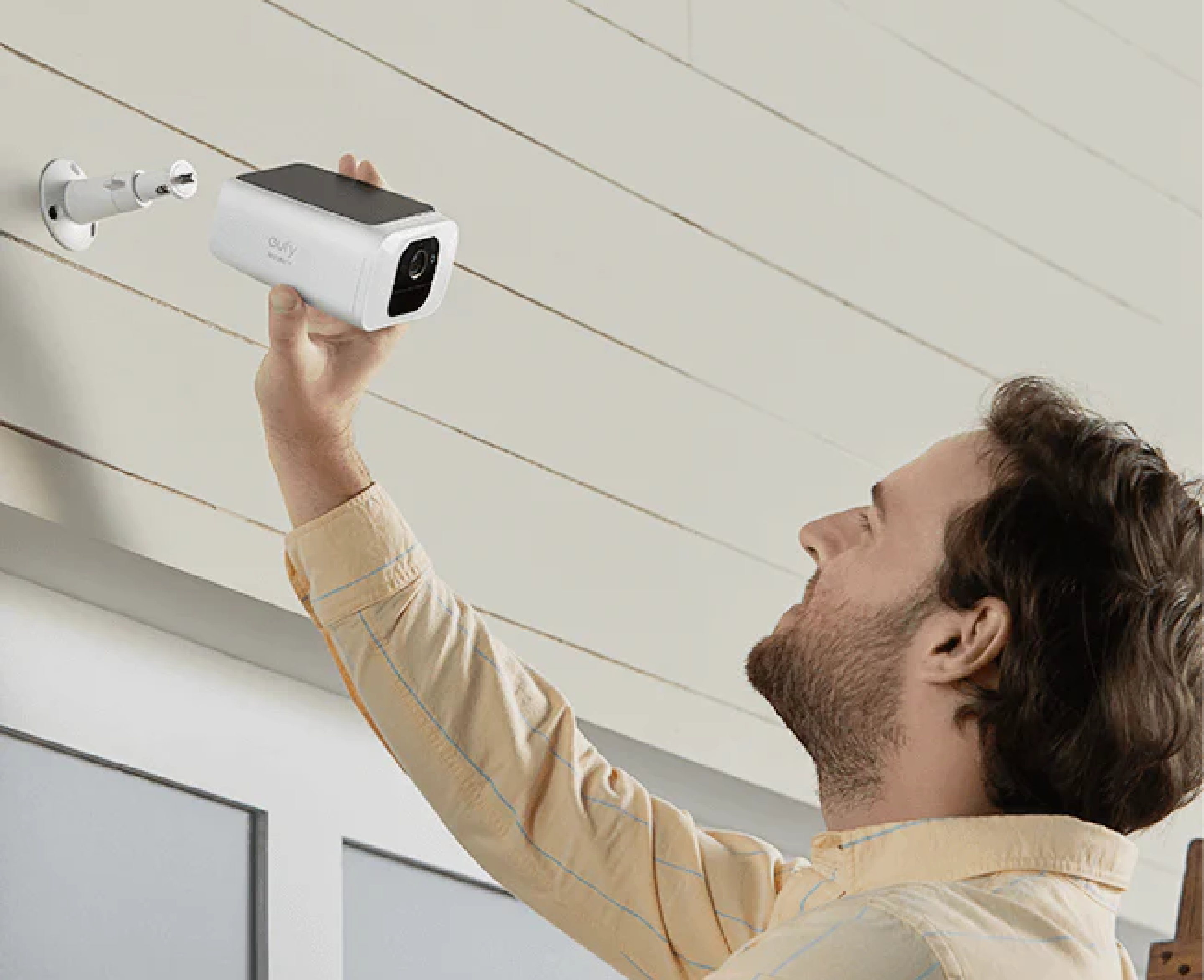 homeowner installing security camera